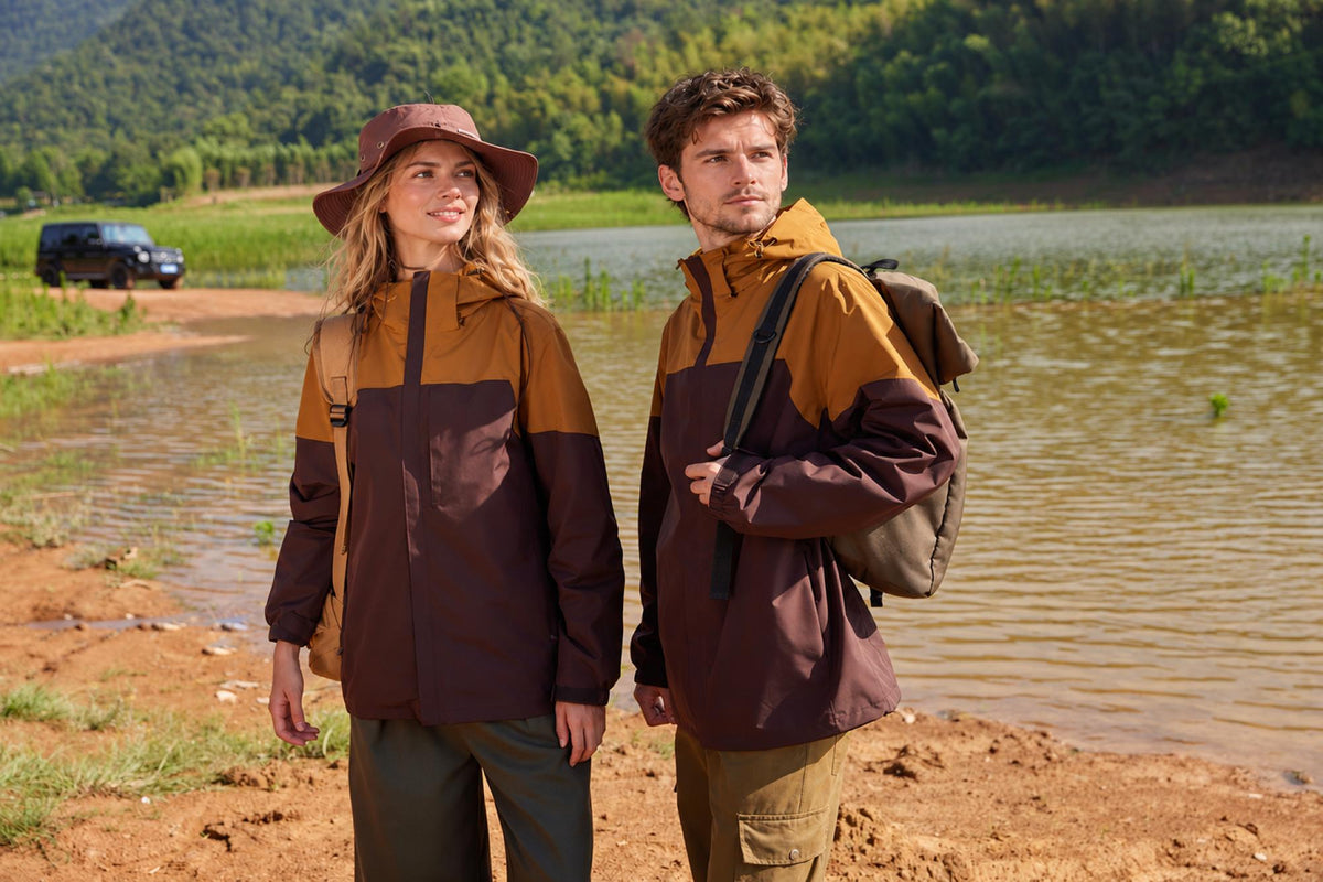 Two people wearing Fernlow 3-in-1 hiking jackets by a lake